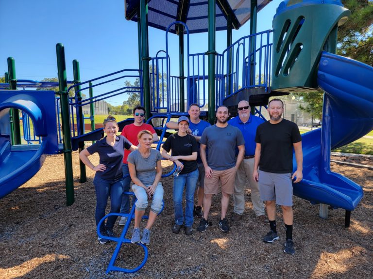 Armada Analytics staff on a playground at a charity event